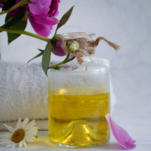 Oil cosmetic flower chamomile on a light background